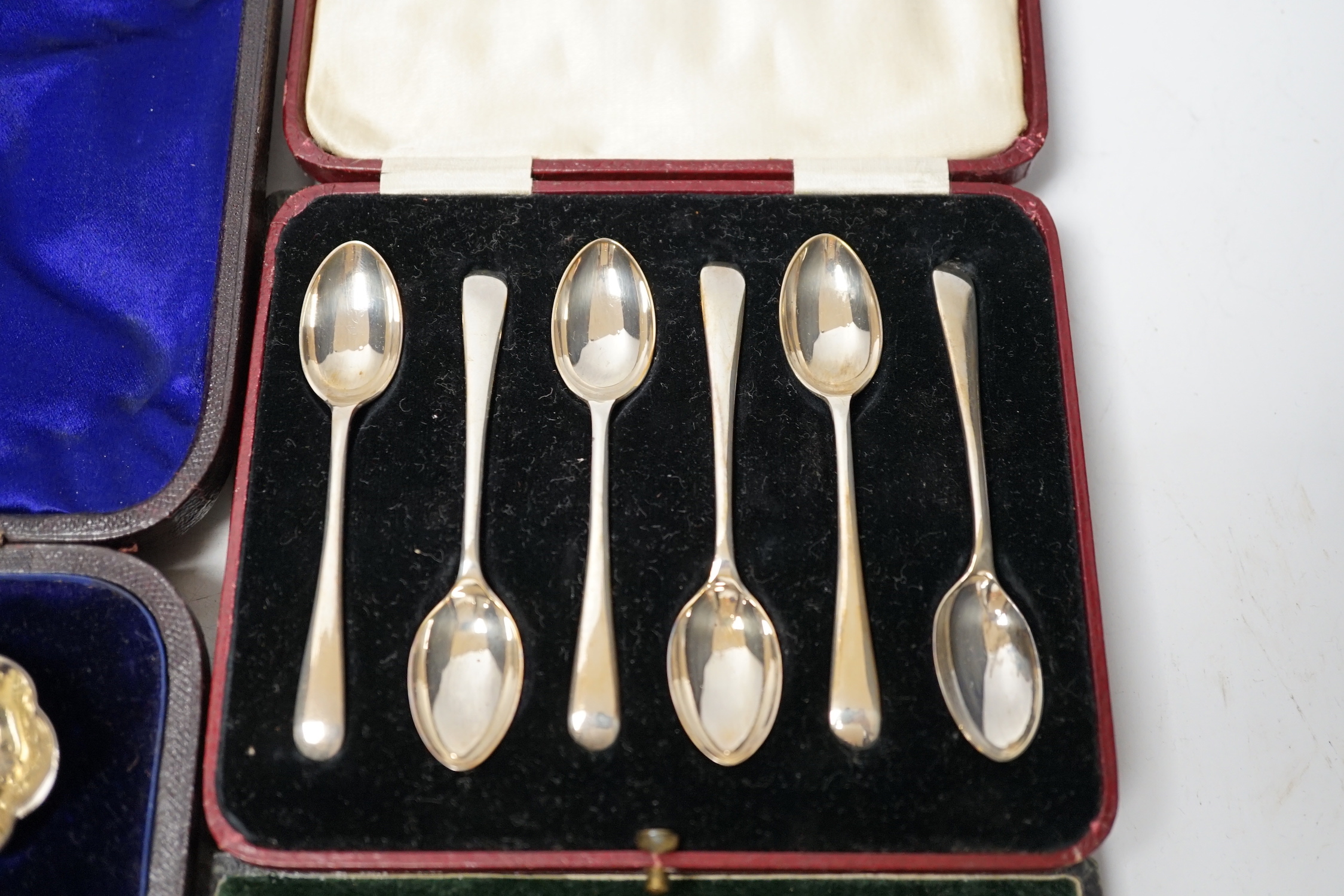 Three assorted cases of silver flatware, including two sets of six silver teaspoons and a 19th matched silver three piece serving and sifter spoon set.